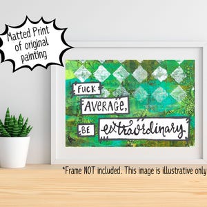 May include: White framed art print with the text "Fuck Average, Be Extraordinary" on a green and white abstract background. The print is displayed on a wooden surface with a white wall in the background.