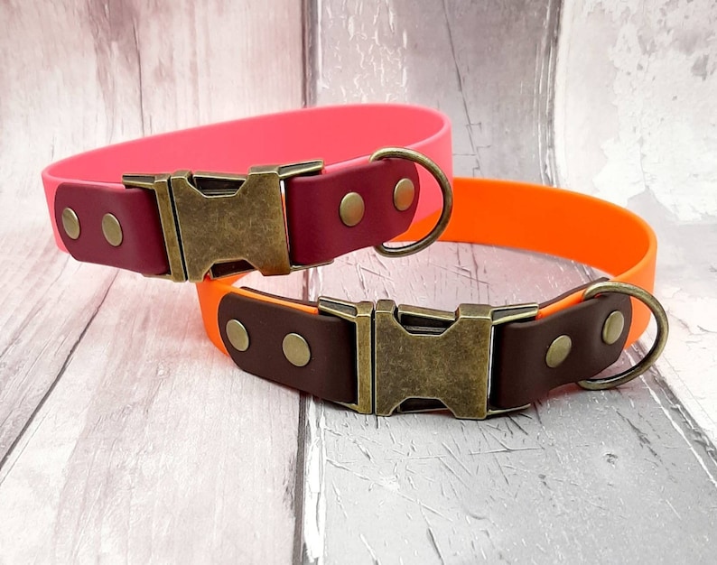 Two Trinkety Paws two-coloured waterproof Biothane Dog Collar, with antique Brass Fast Release Buckle and Fittings, in Baby Pink and Brown on the left and Orange and Dark Brown on the right side.