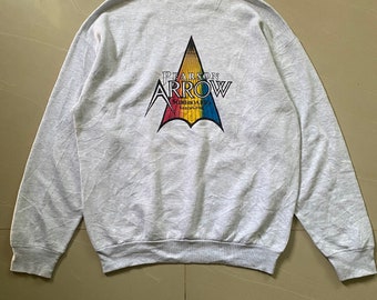 May include: Gray sweatshirt with a colorful logo on the back. The logo is a triangle with the words "Pearson Arrow Surfboards" inside.
