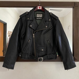 May include: Black leather motorcycle jacket with a zipper closure, a belt, and multiple pockets.