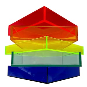 May include: Four stacked acrylic trays in a rainbow color scheme. The top tray is red, the second is orange, the third is yellow, and the bottom tray is blue.