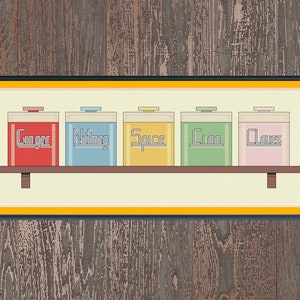 May include: Five colorful spice jars labeled "Ginger", "Nutmeg", "Spice", "Cin", and "Cloves" are arranged on a shelf with a wooden frame.