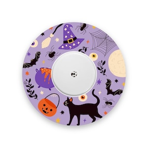 May include: A circular adhesive patch featuring a light purple background with a Halloween-themed pattern of black cats, orange jack-o'-lantern buckets, purple cauldrons, witch hats, bats, spiders, spiderwebs, eyeballs, and stars.