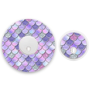 May include: Two round stickers with a mermaid scale pattern in shades of purple, pink, and silver glitter. The larger sticker is 3 inches in diameter and the smaller sticker is 1 inch in diameter.