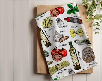 May include: White kitchen towel with a colorful illustration of various Italian food ingredients, including tomatoes, garlic, onions, olive oil, pasta, and herbs. The text "ing onion", "tagliatelle", "garlic", "olive oil", "tomatoes", "spring onion", "olive oil", "spaghetti", "basil", "sourdoug", "asil", "tomato pu", "PURES", "farfalle" is printed on the towel.