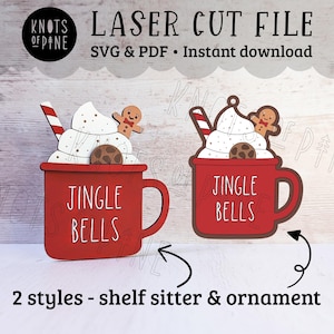 May include: Two styles of laser cut wooden ornaments, each depicting a red mug with white whipped cream, a gingerbread man, and the text "Jingle Bells".