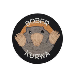 May include: A black and white embroidered patch with a cartoon mole and the text "BOBER KURWA".