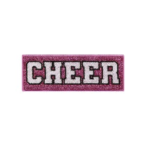 Puede incluir: Parche de hierro con purpurina rosa con la palabra "CHEER" en letras blancas.