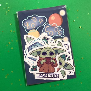 May include: A pack of stickers featuring Baby Yoda from The Mandalorian. The stickers include Baby Yoda with a cup, the words "Yoda Code", and "Java Yoda". The stickers are on a dark blue background with a green background.