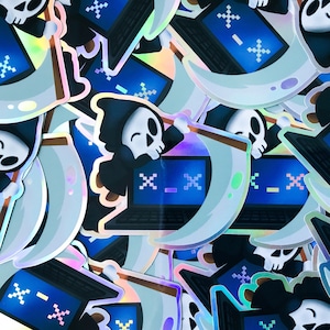 May include: A collection of holographic stickers featuring a cartoon grim reaper holding a scythe and a laptop with a pixelated screen. The stickers are on a white background.
