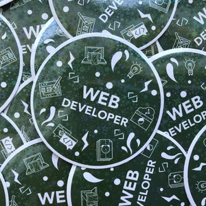 May include: Circular stickers with a dark green background and a holographic sheen. The stickers feature white illustrations of web development tools and the text "WEB DEVELOPER". The design includes code symbols, a lightbulb, and a laptop.