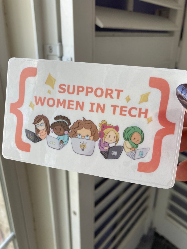 May include: A rectangular sticker with the text "SUPPORT WOMEN IN TECH" in orange. The sticker shows illustrations of five women using laptops. The design includes orange brackets and yellow diamond shapes.