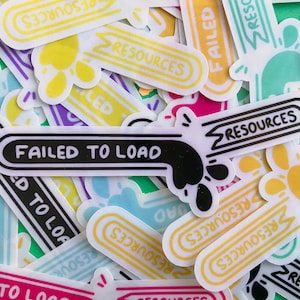 May include: A selection of vibrant stickers featuring the phrases "FAILED TO LOAD" and "RESOURCES" in a prominent black font. The stickers have a distinctive design with a paw-like form and arrow accents, in hues of yellow, pink, and blue.