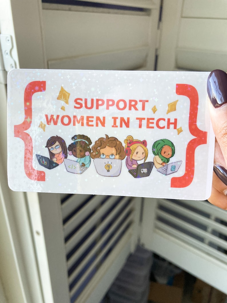 May include: A rectangular sticker with the text "SUPPORT WOMEN IN TECH" in red. The sticker features illustrations of four diverse women working on laptops. The background has a holographic, glittery effect with red and gold accents.