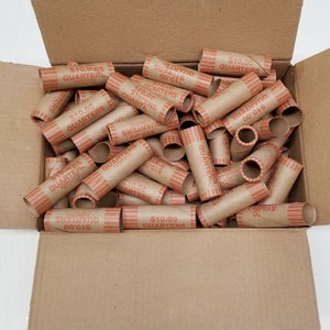 May include: A cardboard box filled with brown paper coin wrappers. Each wrapper has the text "$10.00 QUARTERS" printed on it.