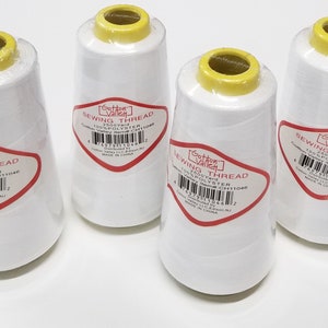 May include: Four large spools of white sewing thread, each wrapped in clear plastic with a yellow top. The labels read Cotton Valley Sewing Thread, 2500 Yard, 100% Polyester, item number CH11046, distributed by Cotton Valley LLC, Edison, NJ, Made in China.