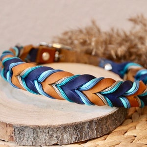 May include: A braided dog collar with brown leather, navy blue, teal and silver accents.