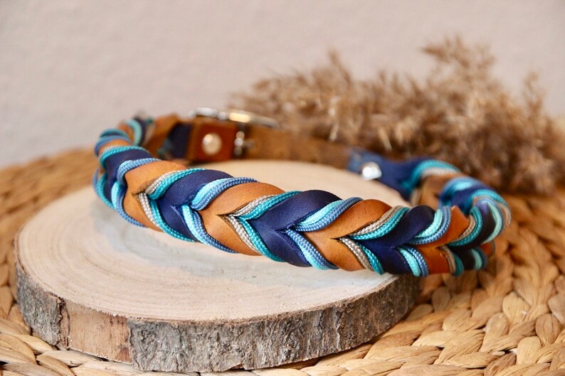 May include: A braided dog collar with brown leather, navy blue, teal and silver accents.
