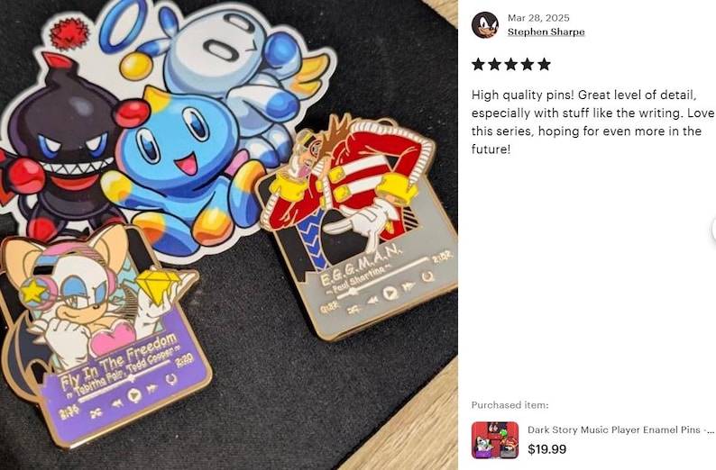 May include: Enamel pins featuring characters from a video game series. The pins include a blue character, a black character, and a character with a diamond. One pin has the text "Fly In The Freedom". Another pin has the text "E.G.G.M.A.N."