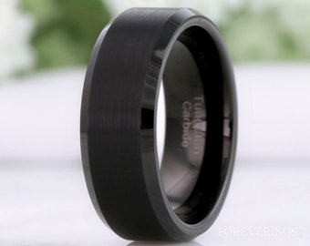 May include: A black tungsten carbide ring with a beveled edge and a brushed finish. The ring is engraved with "Tungsten Carbide".