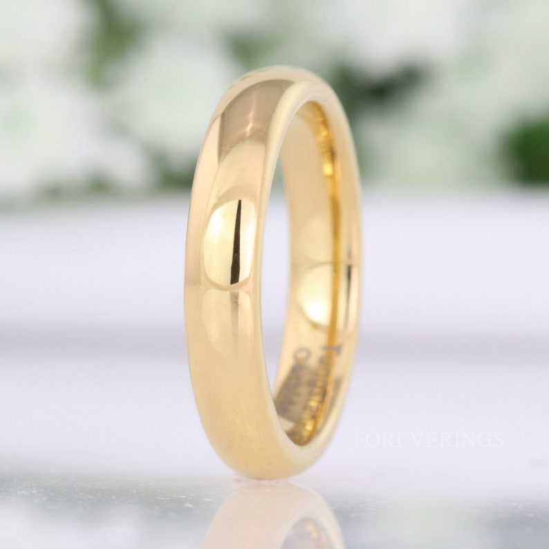 4mm gold tungsten wedding band standing upright, angled to show the polished gold interior