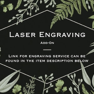 May include: A black background with a white hexagonal frame containing the words "LASER ENGRAVING ADD-ON". The image is decorated with green and white botanical illustrations, and text that says "LINK FOR ENGRAVING SERVICE CAN BE FOUND IN THE ITEM DESCRIPTION BELOW".