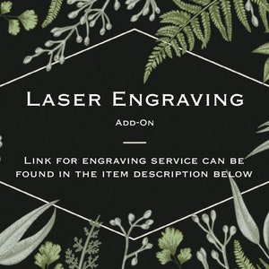 May include: A black and white hexagonal frame with the text "LASER ENGRAVING ADD-ON" and "LINK FOR ENGRAVING SERVICE CAN BE FOUND IN THE ITEM DESCRIPTION BELOW". The frame is surrounded by green and gray botanical illustrations.