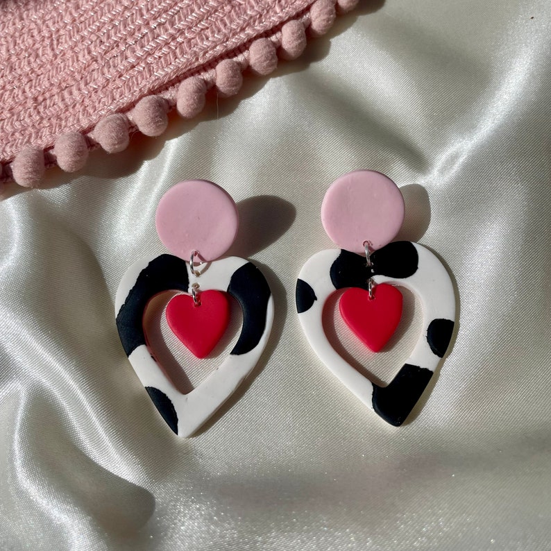 Cut out heart shaped polymer clay cow print earrings with pink and red details and charm image 6