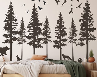 May include: A bedroom with a bed and a wall mural of a forest scene. The mural features silhouettes of pine trees, a bear, a rabbit, a fox, and a squirrel. There are also silhouettes of birds flying in the sky.