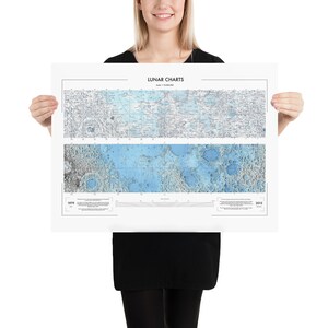 May include: A white poster with the title "Lunar Charts" and a detailed map of the moon's surface. The map shows the moon's surface in 1979 and 2005.