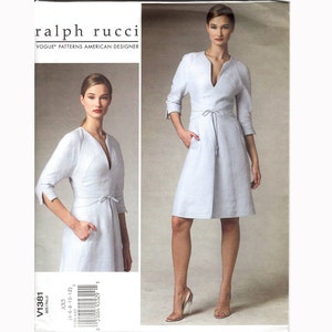 May include: A sewing pattern for a light blue dress with a V-neckline, 3/4 sleeves, and a tie at the waist. The pattern is by Ralph Rucci for Vogue Patterns.
