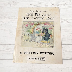 May include: The Tale of the Pie and the Patty Pan by Beatrix Potter, a vintage children's book with a black and white illustration of a black cat holding flowers on the cover.