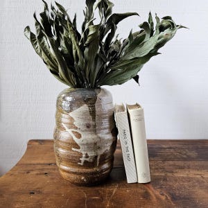 Vintage studio pottery vase in earth tones.