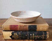 Antique pottery bowl / dish from the Middle East. Light gray over terra cotta clay.