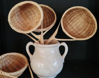 Hand-woven wooden strainer or scoop.