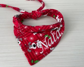 May include: Red Christmas dog bandana with a white snowflake pattern and the word "Nala" embroidered in white.