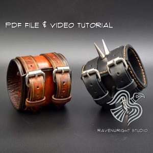 May include: Two leather wrist cuffs, one brown and one black, each featuring two silver-toned metal buckles and straps. The black cuff includes two pointed metal spikes. Text reads: PDF FILE & VIDEO TUTORIAL and RAVENWRIGHT STUDIO.