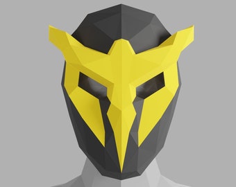 May include: A black and yellow origami mask with a geometric design. The mask has a sharp, angular shape and a pointed beak.