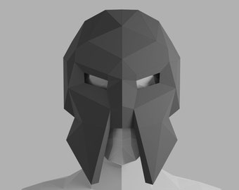 May include: A black, geometric, paper mask with eye holes. The mask is in the shape of a face with a pointed chin and a large, flat nose.