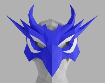 May include: A blue and white origami mask with a geometric design. The mask has a sharp, angular shape and is reminiscent of a bird of prey.