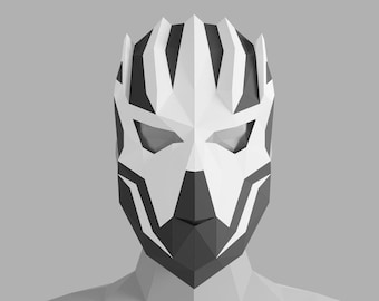 May include: A white and black geometric mask with a sharp, angular design. The mask has a pointed top and a narrow chin. The eyes are covered with black and white geometric shapes.