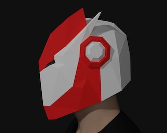 May include: A red and white papercraft mask with a geometric design. The mask has a large, white, hexagonal shape on the side.