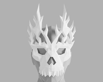 May include: A white paper mask shaped like a skull with a crown of flames. The mask is made of folded paper and has a geometric design.