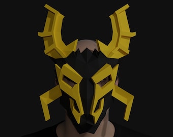 May include: A black and yellow papercraft mask with a geometric design. The mask has two large horns and a pointed nose.
