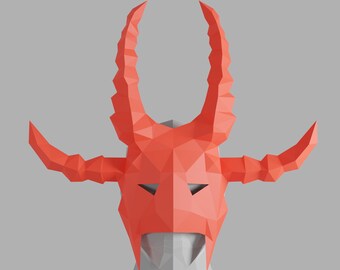 May include: A red origami mask with horns, resembling a devil or demon. The mask is made of paper and has a geometric design.