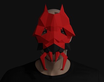 May include: A red and black papercraft mask with a geometric design. The mask has a pointed shape with two horns and a long, pointed snout.