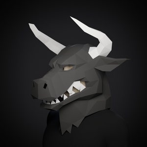 May include: A black papercraft bull mask with white horns. The mask has a fierce expression with sharp teeth and a detailed face.