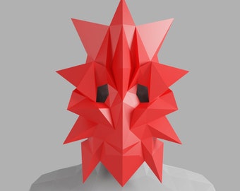 May include: A red geometric mask with a sharp, angular design. The mask has a pointed top and a jagged, spiky edge. It is made of a lightweight material and has a hollow interior.