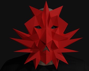 May include: A red geometric mask with sharp points and a triangular shape. The mask covers the face and has eye holes.