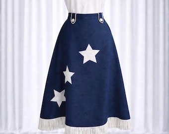 May include: A navy blue skirt with white star appliques and a white fringe hem. The skirt has a high waist with white button details. The skirt is paired with a white t-shirt.